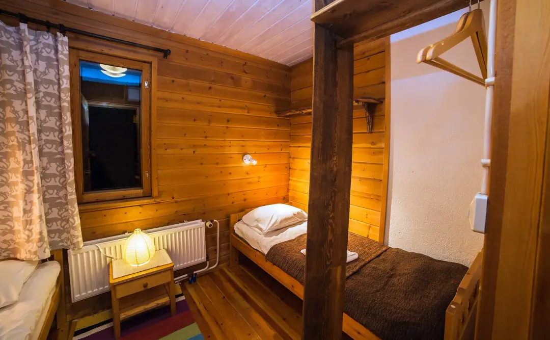 Cosy cabin bedroom with bunk beds and warm lighting